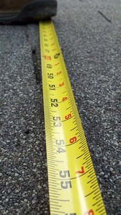 Measuring tape on asphalt 176